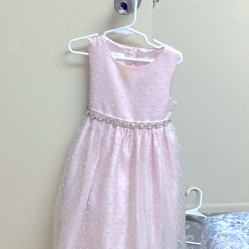 A beautiful dress with a long rope and beautiful gems around the dress